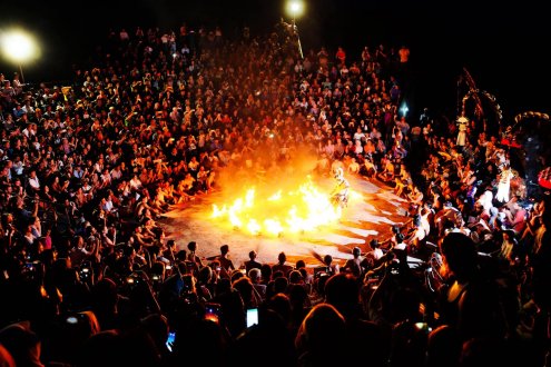 A shot of the bright orange and yellow bonfire at the Kecak fire dance in Bali, Indonesia 